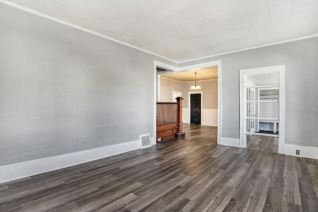 unfurnished living room featuring crown molding, a chandelier, visible vents, and dark wood-type flooring