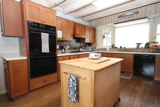 kitchen with custom exhaust hood, backsplash, beamed ceiling, dark wood-style floors, and black appliances