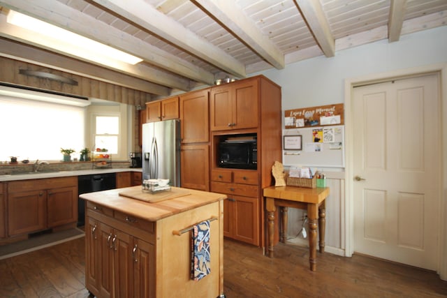 kitchen featuring a sink, wood counters, black appliances, and beamed ceiling