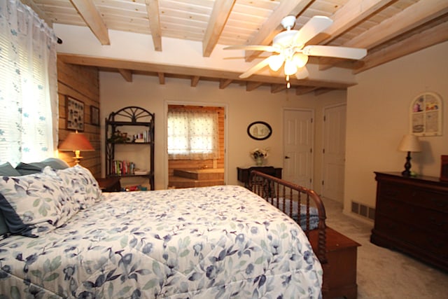 bedroom featuring visible vents, carpet, beam ceiling, and multiple windows
