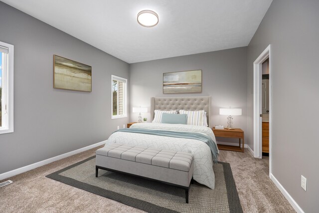 bedroom with carpet floors, baseboards, and visible vents