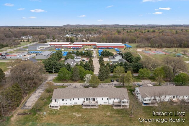 birds eye view of property featuring a view of trees