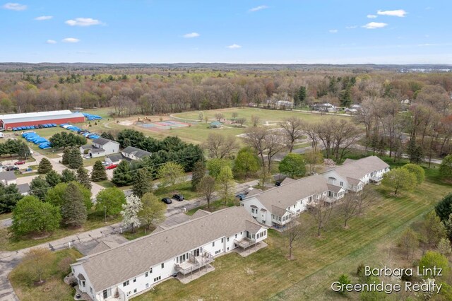 drone / aerial view featuring a wooded view