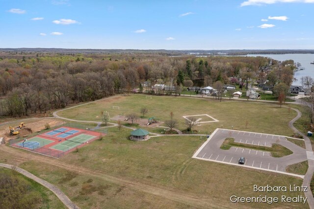 birds eye view of property with a view of trees and a water view