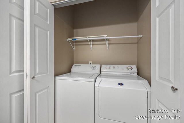 washroom featuring laundry area and washer and clothes dryer