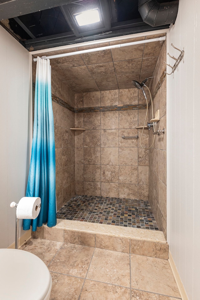 full bath featuring a shower stall and toilet