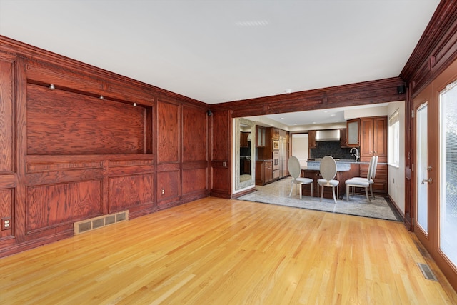 living area with visible vents and light wood-style flooring