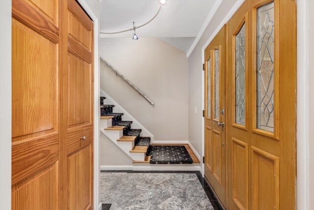 entryway with baseboards and stairs