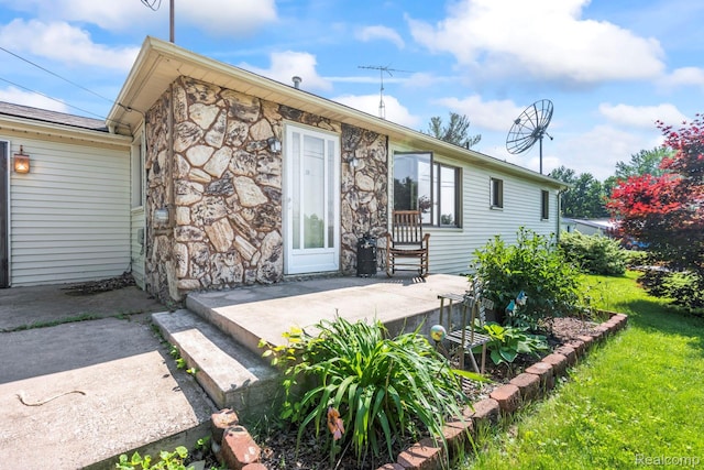 5304 E Frances Rd, Mount Morris, MI 48458 - view of front of property featuring stone siding, a patio area, and a front lawn