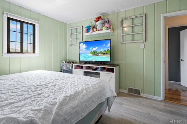 5304 E Frances Rd, Mount Morris, MI 48458 - bedroom featuring wood finished floors, baseboards, and a decorative wall