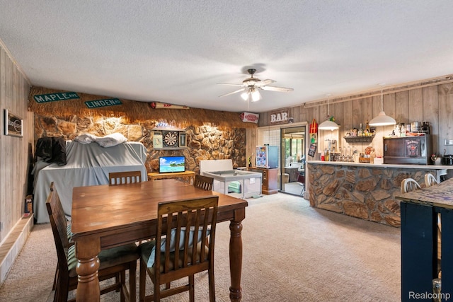 5304 E Frances Rd, Mount Morris, MI 48458 - dining space with light carpet, wood walls, a ceiling fan, and a textured ceiling