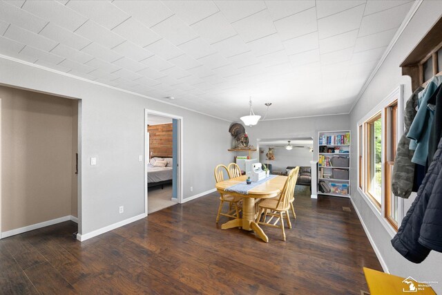dining area with a ceiling fan, baseboards, ornamental molding, and wood finished floors