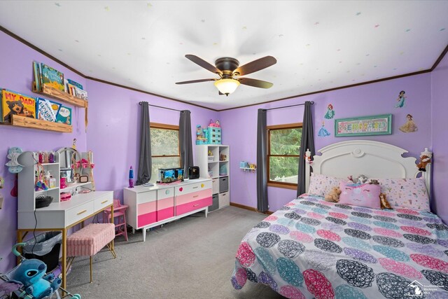 carpeted bedroom featuring crown molding, a ceiling fan, baseboards, and multiple windows