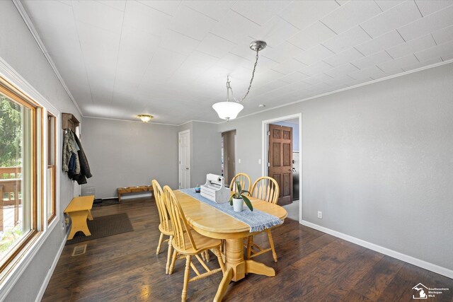dining room featuring visible vents, baseboards, crown molding, and wood finished floors