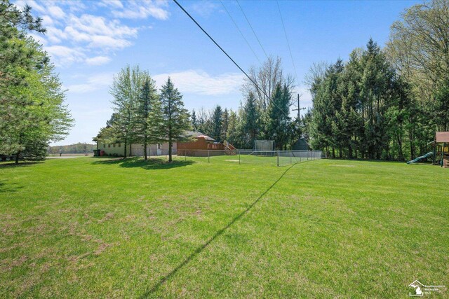 view of yard with fence and a playground