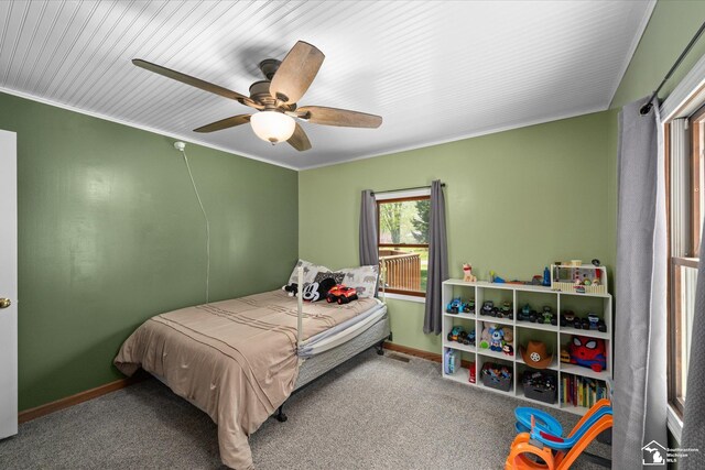 bedroom featuring carpet flooring, baseboards, crown molding, and ceiling fan