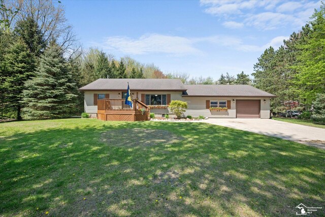 ranch-style home featuring an attached garage, driveway, a deck, and a front yard