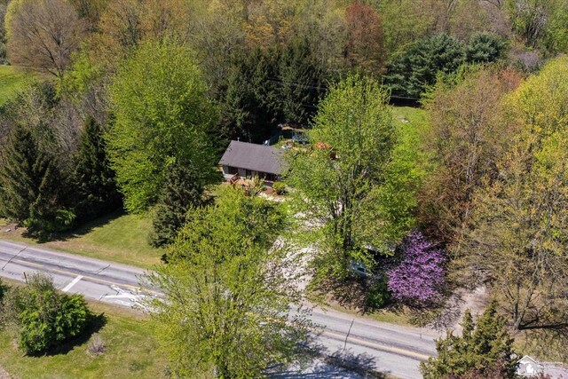 birds eye view of property with a forest view
