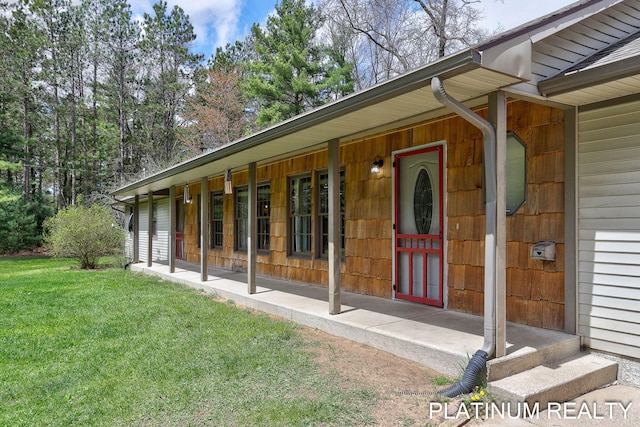 4334 Brunswick Rd, Holton, MI 49425 - view of exterior entry featuring a yard