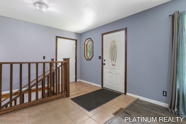 4334 Brunswick Rd, Holton, MI 49425 - entrance foyer with light tile patterned floors and baseboards