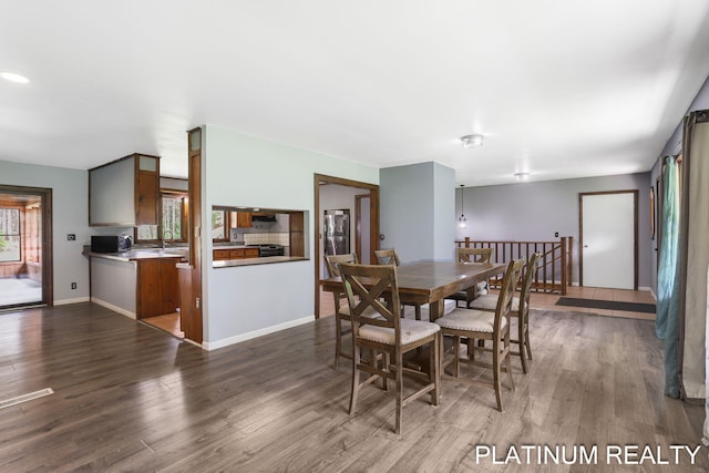 4334 Brunswick Rd, Holton, MI 49425 - dining room featuring wood finished floors and baseboards