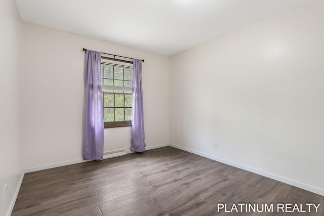 4334 Brunswick Rd, Holton, MI 49425 - spare room featuring wood finished floors, baseboards, and a baseboard heating unit