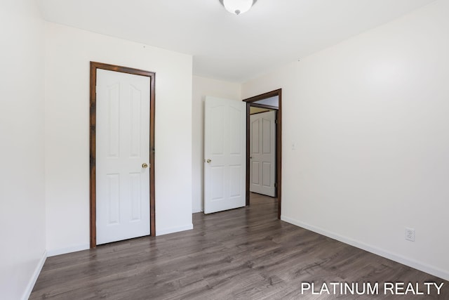 4334 Brunswick Rd, Holton, MI 49425 - unfurnished bedroom with wood finished floors and baseboards