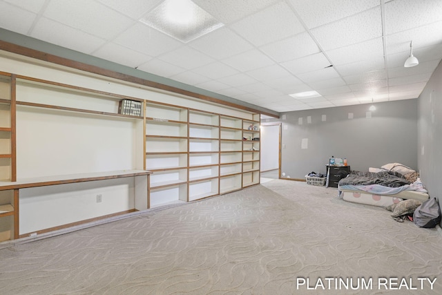 4334 Brunswick Rd, Holton, MI 49425 - finished basement with carpet flooring, a paneled ceiling, and baseboards