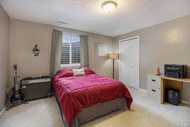 bedroom with baseboards, visible vents, a textured ceiling, and light colored carpet