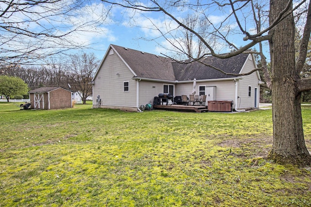 back of house with a storage shed, an outbuilding, a yard, and a deck