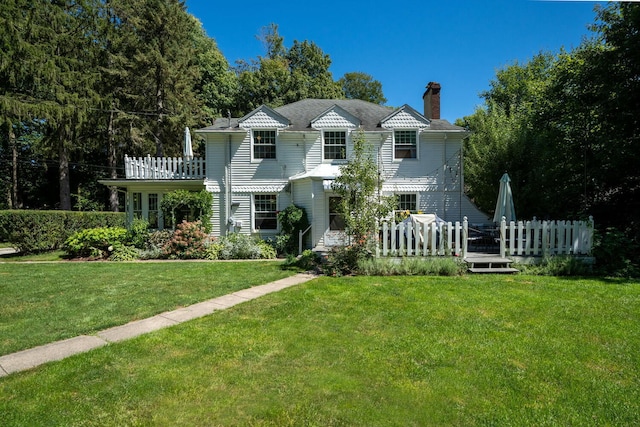 61412 Walnut St, Cassopolis, MI 49031 - view of front of home featuring a wooden deck, fence, a front yard, and a chimney