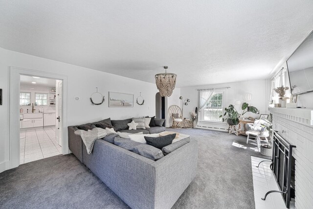 61412 Walnut St, Cassopolis, MI 49031 - carpeted living room with a textured ceiling, an inviting chandelier, and a fireplace