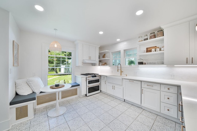61412 Walnut St, Cassopolis, MI 49031 - kitchen with open shelves, decorative backsplash, white appliances, light countertops, and a sink