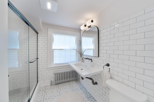 61412 Walnut St, Cassopolis, MI 49031 - bathroom with toilet, tile walls, radiator heating unit, plenty of natural light, and a shower stall