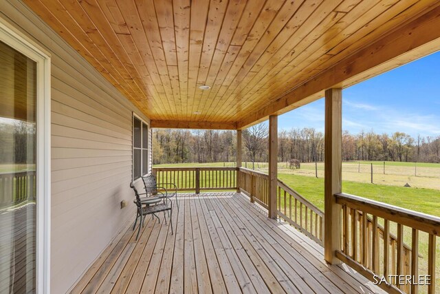 wooden deck featuring a yard