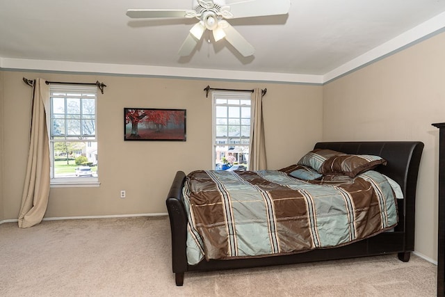 carpeted bedroom with baseboards and a ceiling fan