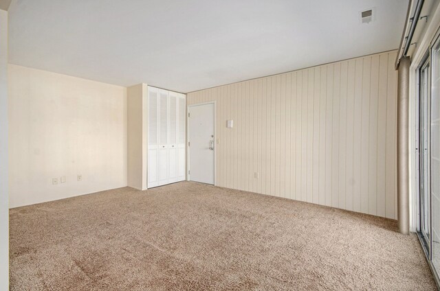 carpeted spare room with visible vents