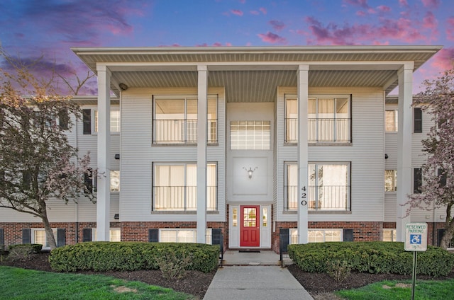 multi unit property with covered porch and brick siding