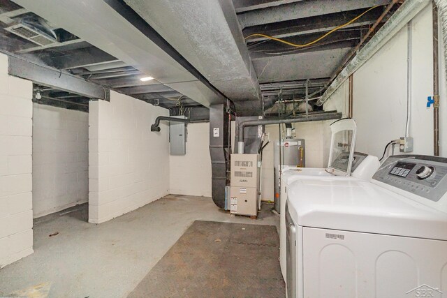 unfinished below grade area featuring gas water heater, electric panel, visible vents, heating unit, and washer and dryer