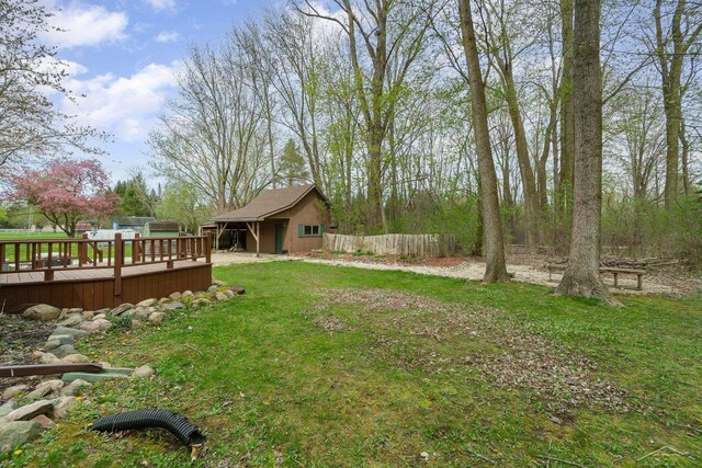 view of yard featuring fence and a wooden deck