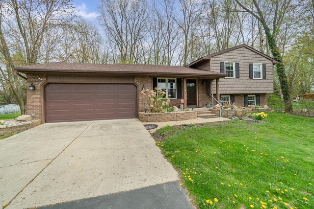 tri-level home featuring a garage, a front lawn, covered porch, brick siding, and driveway