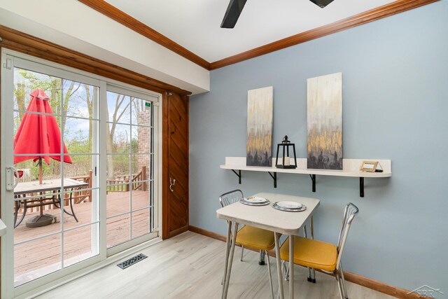 dining area with ceiling fan, ornamental molding, wood finished floors, and a wealth of natural light