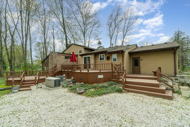 back of house with a deck