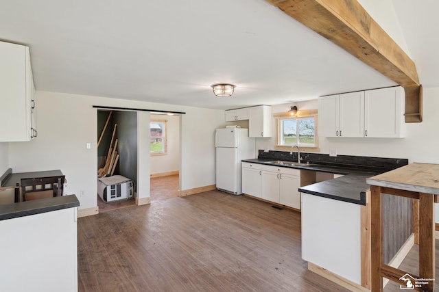 13280 Burt Rd, Pittsford, MI 49271 - kitchen with dark countertops, white cabinets, freestanding refrigerator, and dark wood finished floors