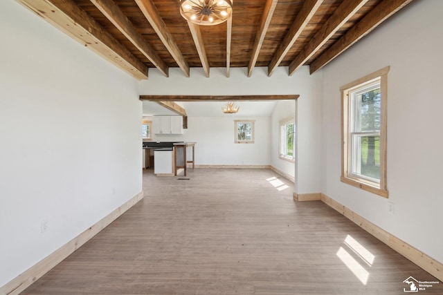13280 Burt Rd, Pittsford, MI 49271 - unfurnished living room with beam ceiling, baseboards, light wood-type flooring, wooden ceiling, and a notable chandelier