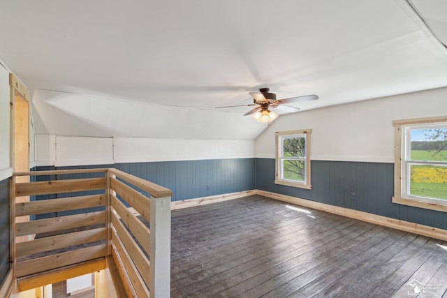 13280 Burt Rd, Pittsford, MI 49271 - additional living space with a wainscoted wall, a ceiling fan, a wealth of natural light, and hardwood / wood-style floors