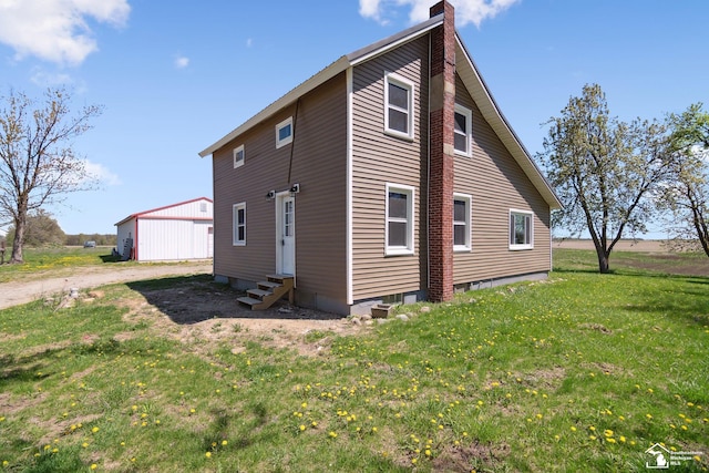 13280 Burt Rd, Pittsford, MI 49271 - rear view of property with a yard, a chimney, and entry steps