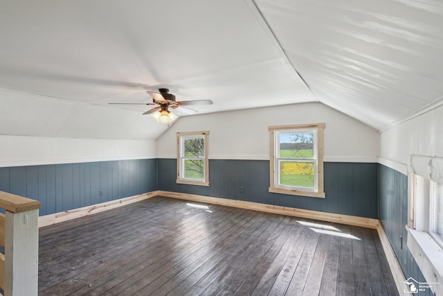 13280 Burt Rd, Pittsford, MI 49271 - bonus room with wood-type flooring, wooden walls, a wainscoted wall, a ceiling fan, and vaulted ceiling