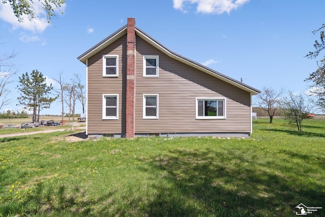 13280 Burt Rd, Pittsford, MI 49271 - rear view of house featuring a lawn and a chimney