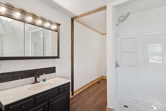 13280 Burt Rd, Pittsford, MI 49271 - full bathroom featuring vanity, baseboards, decorative backsplash, wood finished floors, and a stall shower